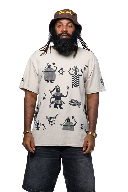 Man wearing a beige t-shirt with black screen printed African graphics and a brown Cooyah bucket hat on a white background.