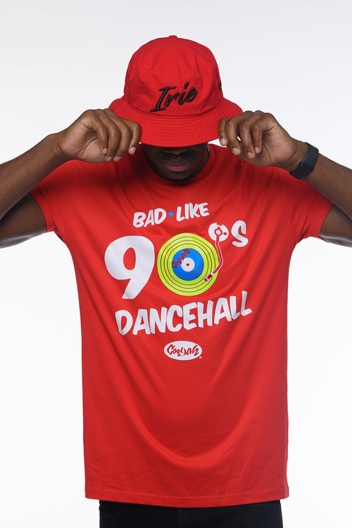 Person wearing a red 'Bad Like 90s Dancehall' t-shirt and matching cap on a white background