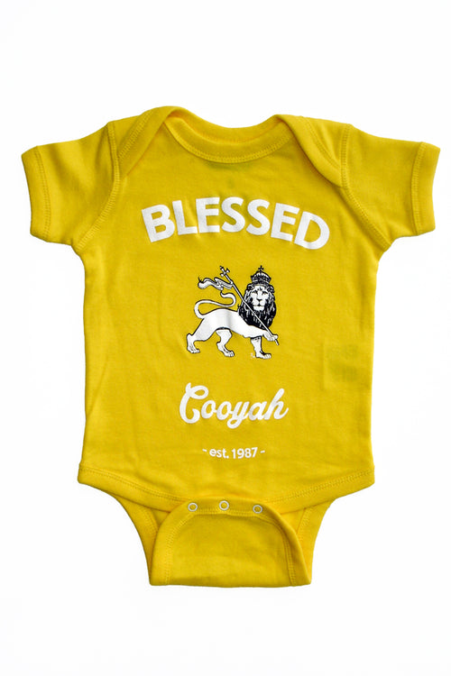 Cooyah Jamaica.  Blessed Rasta Lion Baby Onesie in yellow.  Soft, ringspun cotton.   We are a Jamaican owned clothing brand.  Established in 1987.