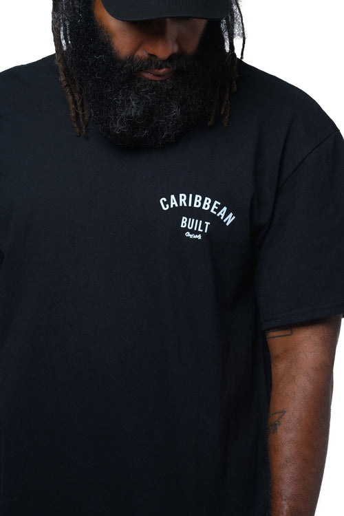 Man wearing a black t-shirt with 'Caribbean Built' text with Cooyah logo on a white background.