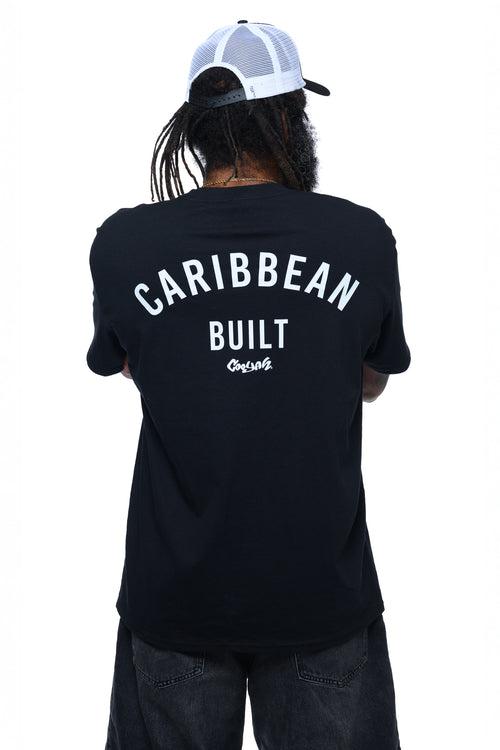 Man wearing a black t-shirt with 'Caribbean Built' text on the back and Cooyah logo while standing against a white background.