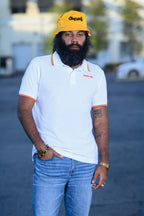 Men's white embroidered Cooyah 1987 One love polo.  We are a Jamaican owned streetwear clothing brand since 1987.