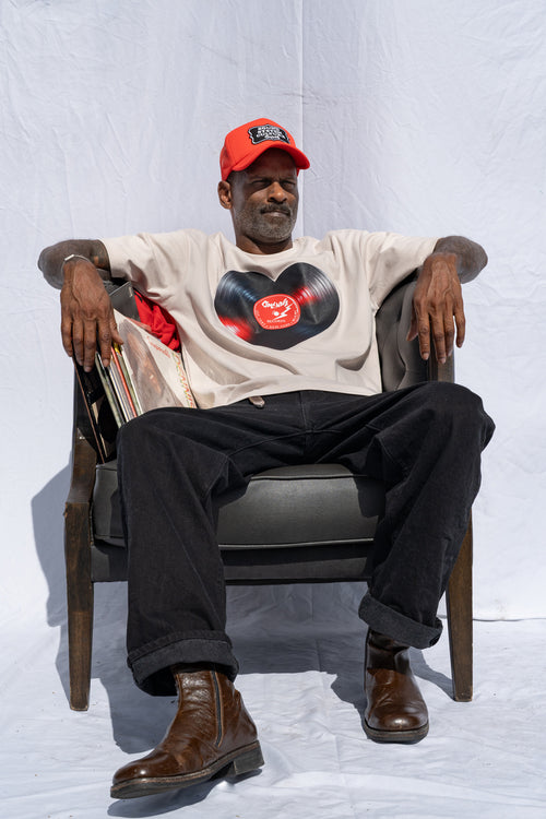 Cooyah men's heart shaped vinyl graphic tee printed on a boxy style sand colored shirt. Paired with a Reggae Massive cap.