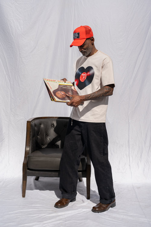 Cooyah men's heart shaped vinyl graphic tee printed on a boxy style sand colored shirt. Paired with a Reggae Massive cap.