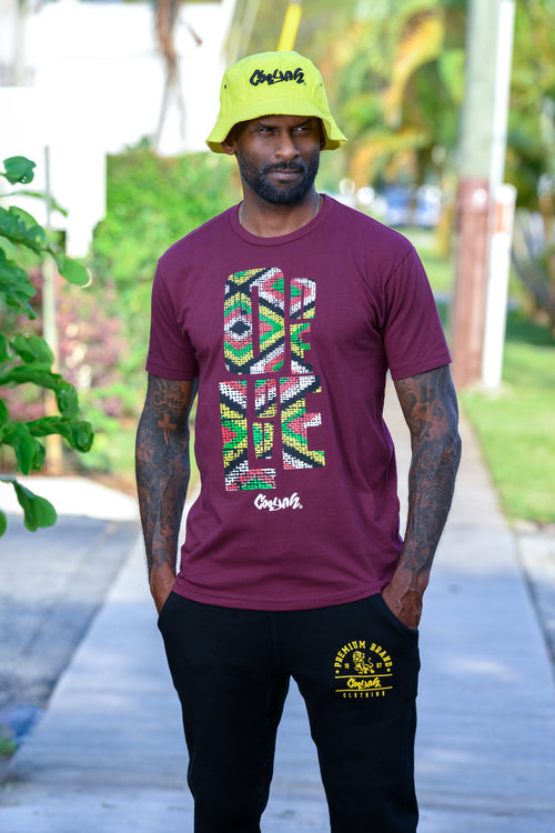 Cooyah Jamaica. One Love Africa Print graphic tee. Men's short sleeve, ringspun cotton tee in burgundy. Jamaican clothing brand.