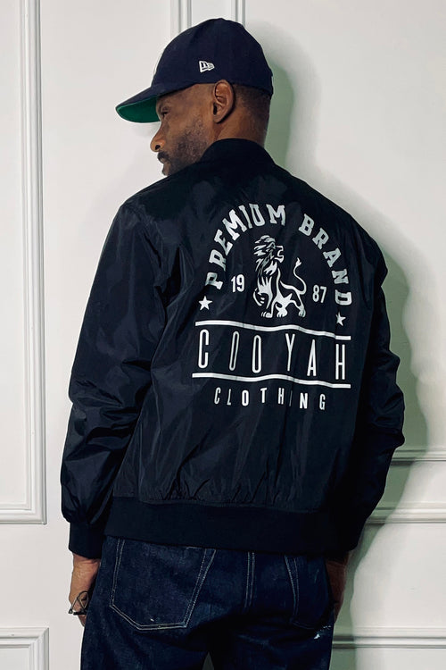Cooyah Jamaica - Men's quilted black Lion Bomber Jacket with Premium Brand graphic. We are a Jamaican owned clothing brand established since 1987. IRIE