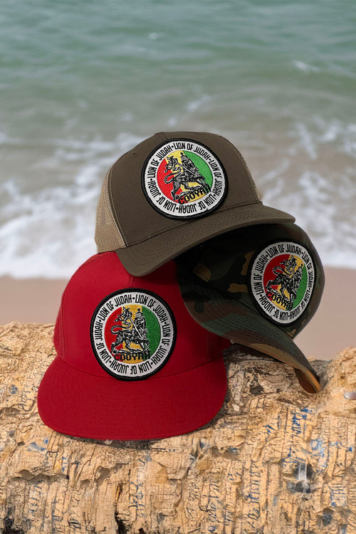 Cooyah Jamaica. Lion of Judah trucker hats in camoflouge, brown, and red. As a Jamaican owned clothing brand since 1987, we take pride in bringing you this classic cap.