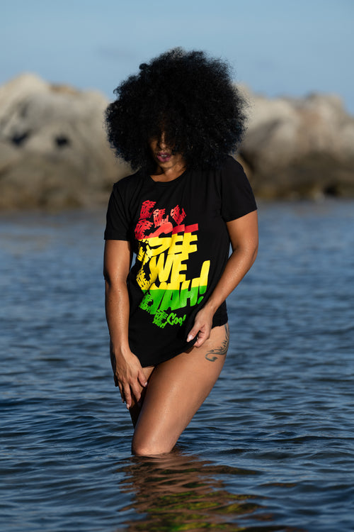 Cooyah Jamaica. Women's black graphic tee with See We Yah Jamaican patois graphics in reggae colors. Short sleeve, crew neck, ringspun cotton.