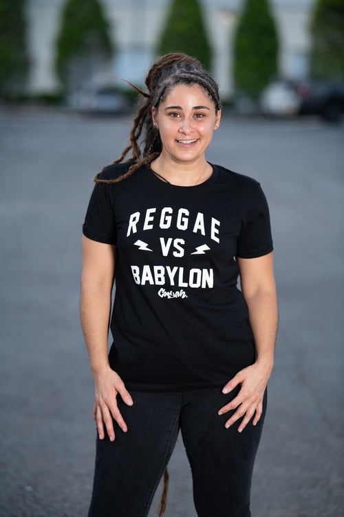 Reggae VS Babylon - Women's black short sleeve graphic tee by Cooyah.  As a Jamaican owned clothing brand since 1987, we take pride in bringing you this classic shirt.