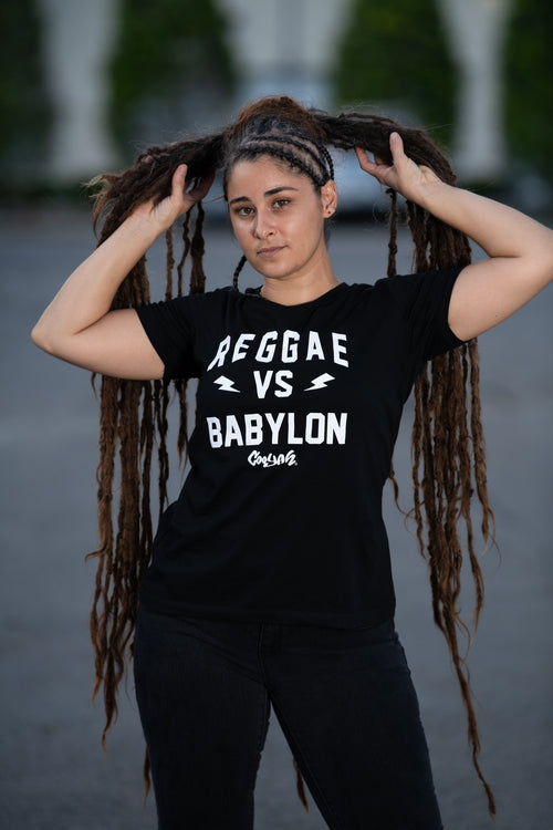 Reggae VS Babylon - Women's graphic tee by Cooyah.  As a Jamaican owned clothing brand since 1987, we take pride in bringing you this classic piece. Don't wait, get yours now!