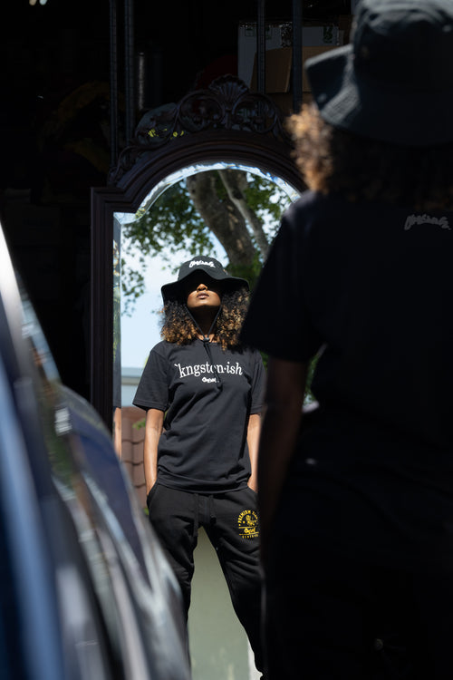 Cooyah Clothing. Kingstonish graphic tee. Women's black t-shirt. Kingston, Jamaica.  As a Jamaican owned clothing brand since 1987, we take pride in bringing you this classic piece.