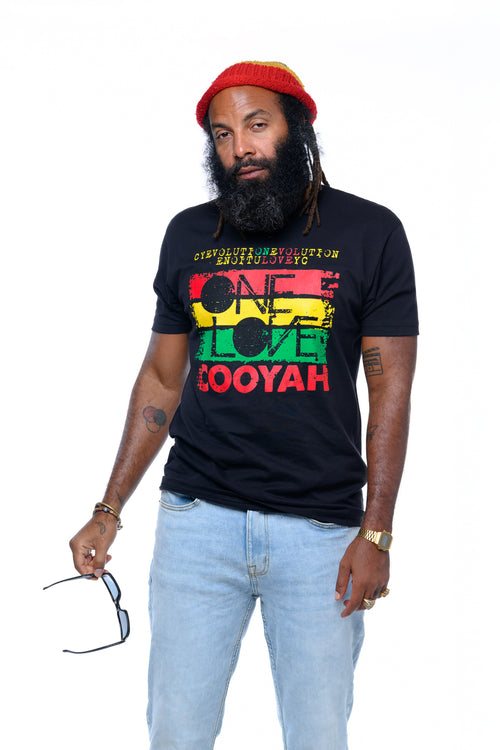 Cooyah Clothing Brand- Reggae artist, Lan Lawd wearing a black t-shirt with 'One Love' Evolution text and graphics in rasta colors, red beanie, and sunglasses on a white background.