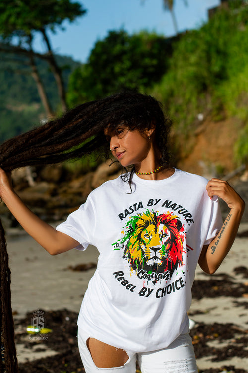 Cooyah Jamaica women's white t-shirt with a colorful rasta lion graphic and text 'Rasta By Nature, Rebel By Choice.'