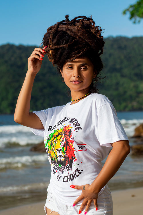 Cooyah Jamaica women's white t-shirt with a colorful rasta lion graphic and text 'Rasta By Nature, Rebel By Choice.'