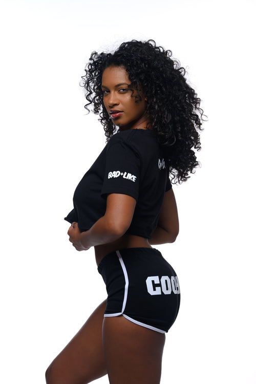 Cooyah Jamaica.  Women's black athleisure shorts with white piping and design screen printed on the back. We are a Jamaican owned clothing brand established in 1987.