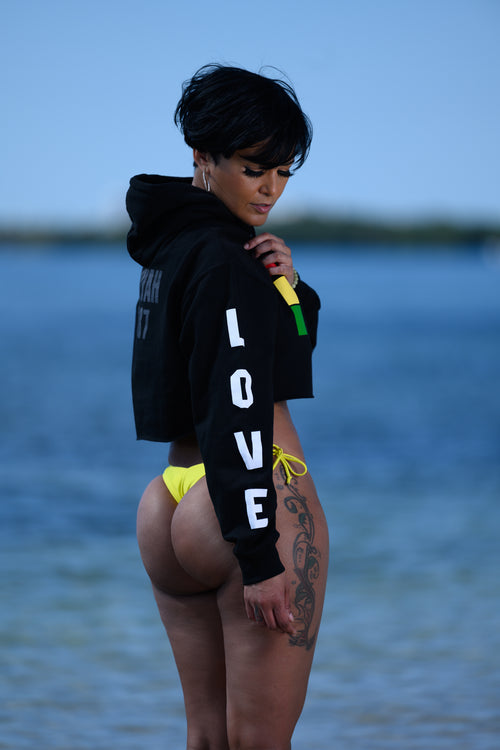 Cooyah Clothing - Women's cropped hoodie with Irie on the front in reggae colors and love print on the sleeve.