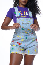 Womens purple Yea Mon shirt with colorful screen printed graphics.  Soft, 100% cotton fabric.  Hand-painted shortalls in reggae colors. Cooyah - Jamaican owned clothing brand.