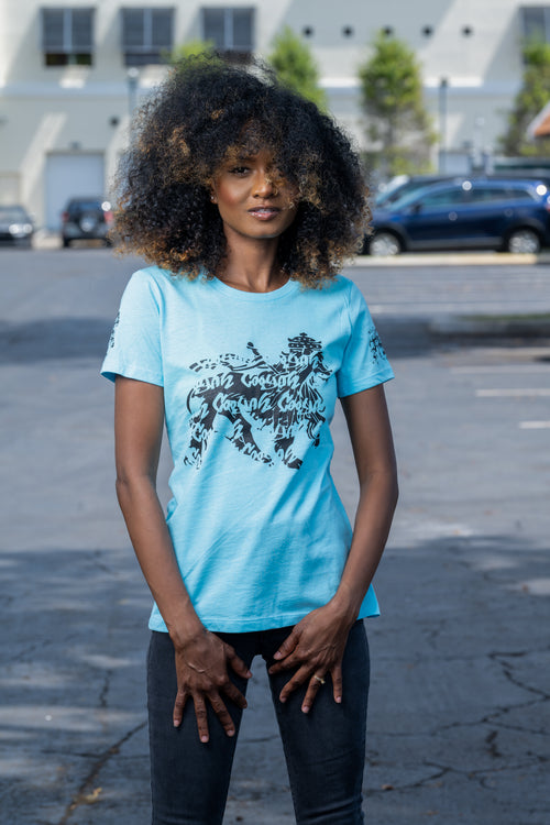 Cooyah rasta lion graphic tee. Women's light blue t-shirt with black lion graphics screen printed on the front and sleeves. Jamaican clothing brand.