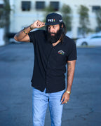 Men's black snapback hat with Yes I embroidered graphic in reggae colors.