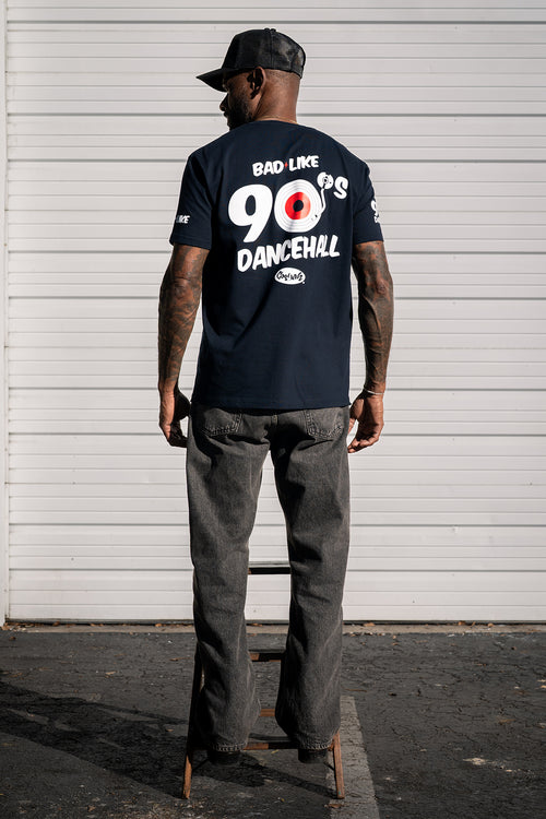 Back view of model wearing Cooyah Bad Like 90s Dancehall graphic t-shirt, featuring bold reggae-inspired back print.