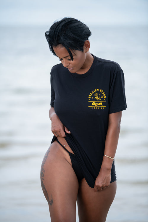 Cooyah Jamaica. Women's boyfriend fit Premium Brand Lion Print Tee. Black with a gold print. Ringspun cotton, short sleeve, shirt. Jamaican clothing brand