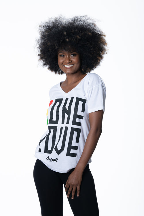 Cooyah Jamaica. One Love women's graphic tee in white. V-Neck, short sleeve, ringspun cotton screen printed in reggae colors. Jamaican clothing brand.