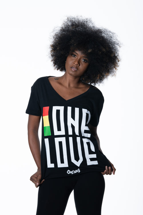 Cooyah Jamaica. One Love women's graphic tee in black. V-Neck, short sleeve, ringspun cotton screen printed in reggae colors. Jamaican clothing brand.