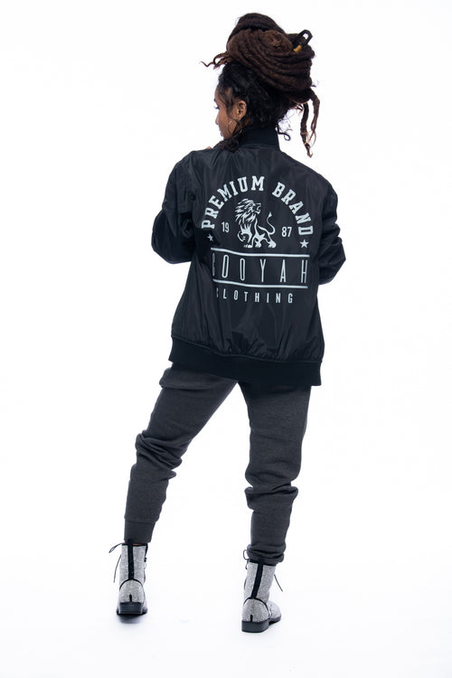 Cooyah Jamaica, Womens Premium Brand Lion Bomber Jacket in black.  As a Jamaican owned clothing brand since 1987, we take pride in bringing you this classic piece.