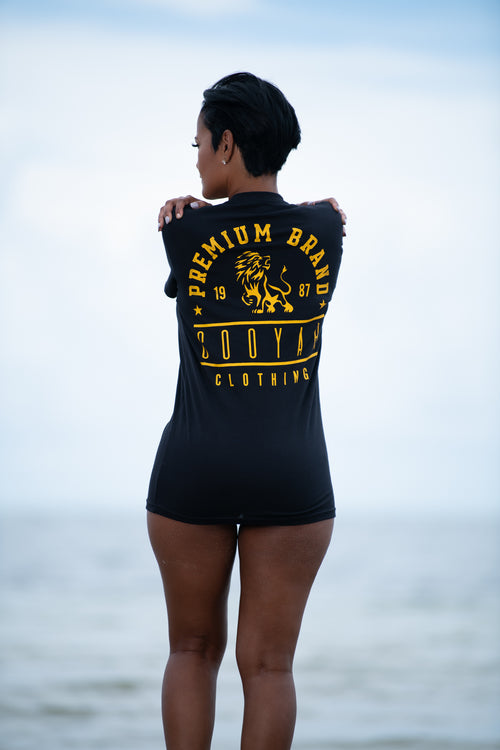 Cooyah Jamaica. Women's boyfriend fit Premium Brand Lion Print Tee. Black with a gold print. Ringspun cotton, short sleeve, shirt. Jamaican clothing brand.