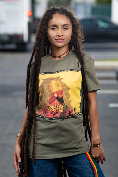 Cooyah Clothing. Haile Selassie Rastafari Lion graphic tee in olive green. Crew neck, short sleeve, soft, ringspun cotton. As a Jamaican owned clothing brand since 1987, we take pride in bringing you this classic rasta shirt.