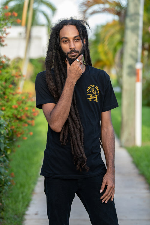 Cooyah Jamaica. Men's Premium Brand graphic tee. Gold Lion design screen printed on a black ringspun cotton t-shirt. Jamaican streetwear clothing brand.