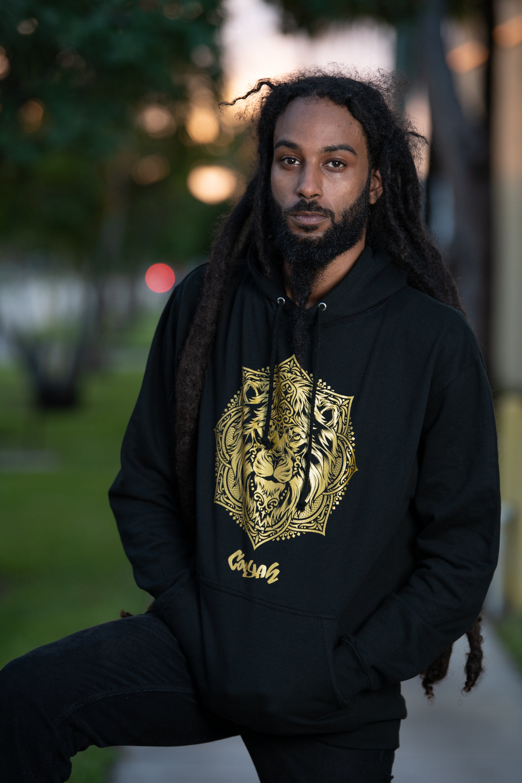 Cooyah Jamaica.   Men's black Lion Mandala hoodie with gold graphics.  Jamaican streetwear clothing brand.