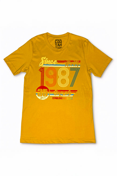 Cooyah - Men's 1987 graphic tee in mustard gold.  Screen printed on soft 100% rinspun cotton with a vintage feel.  