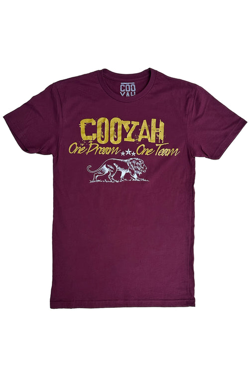 Cooyah Jamaica.  One Dream, One Team, men's graphic tee in burgundy with metallic gold lettering and white lion print.  As a Jamaican owned clothing brand since 1987, we take pride in bringing you this classic piece. Don't wait, get yours now!