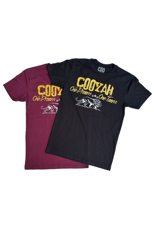 Cooyah Jamaica. One Dream, One Team, men's graphic tees available in burgundy with metallic gold lettering and white lion print.