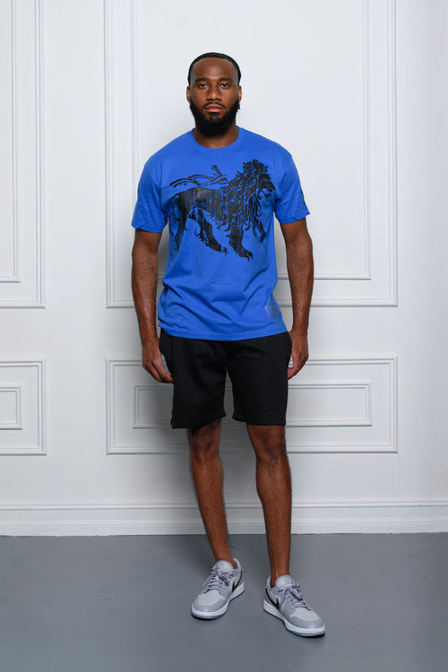 Cooyah Jamaica. Rasta Lion men's short sleeve graphic tee in royal blue. Model: Tre'quan Smith from the Detroit Lions. We are a Jamaican owned streetwear clothing brand established in 1987.