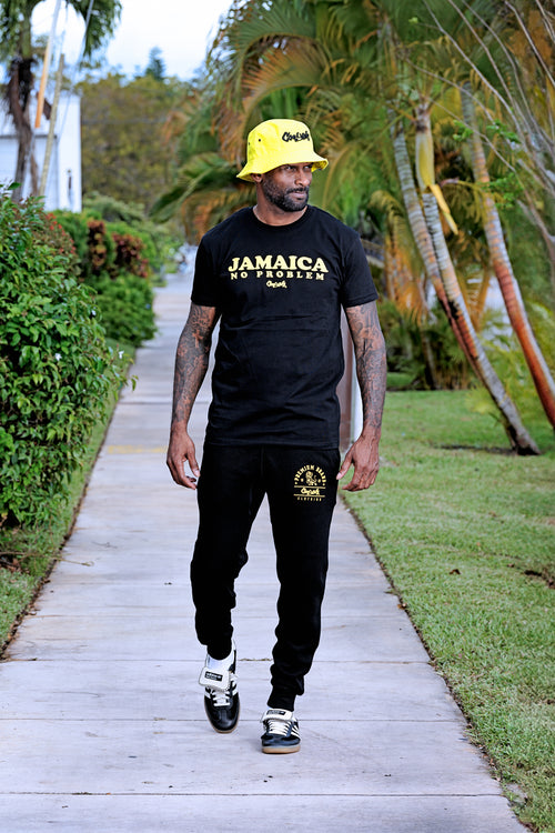 Cooyah Clothing. Men's Premium Brand Joggers in black with gold Lion graphic.  We are a Jamaican streetwear clothing brand established in 1987.