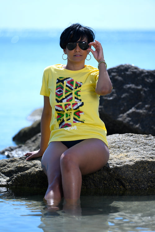 Cooyah Jamaica. One Love Africa Print graphic tee. Women's short sleeve, ringspun cotton tee in yellow. Jamaican clothing brand.