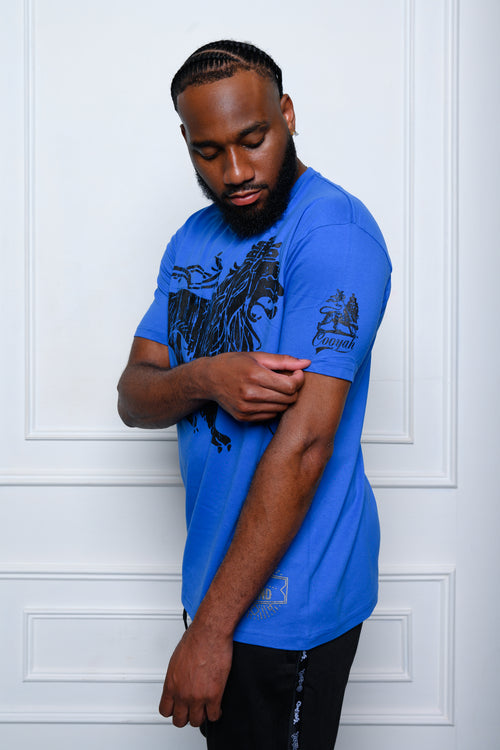 Cooyah Jamaica. Rasta Lion men's short sleeve graphic tee in royal blue. Model: Tre'quan Smith from the Detroit Lions. We are a Jamaican owned streetwear clothing brand established in 1987.