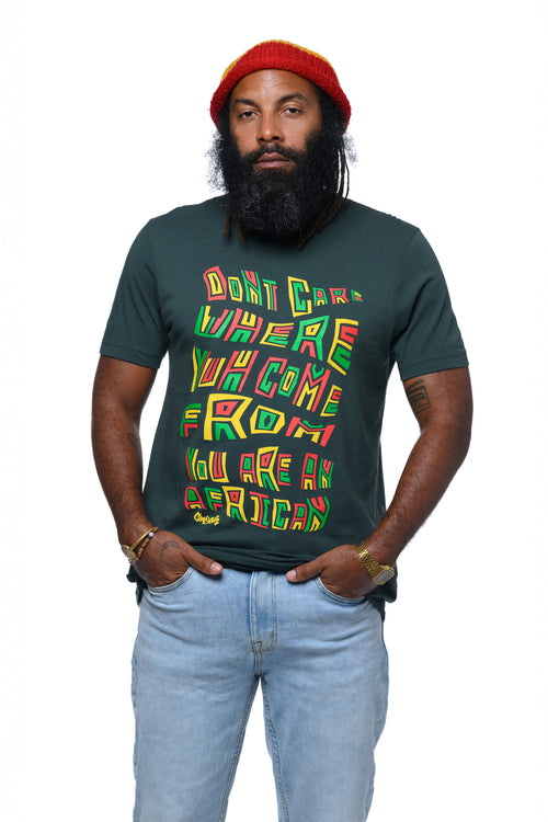 Rasta man wearing a dark green t-shirt with colorful text 'Don't care where you come from you are an African" and a red knit beanie on a white background.  Cooyah Clothing Brand.