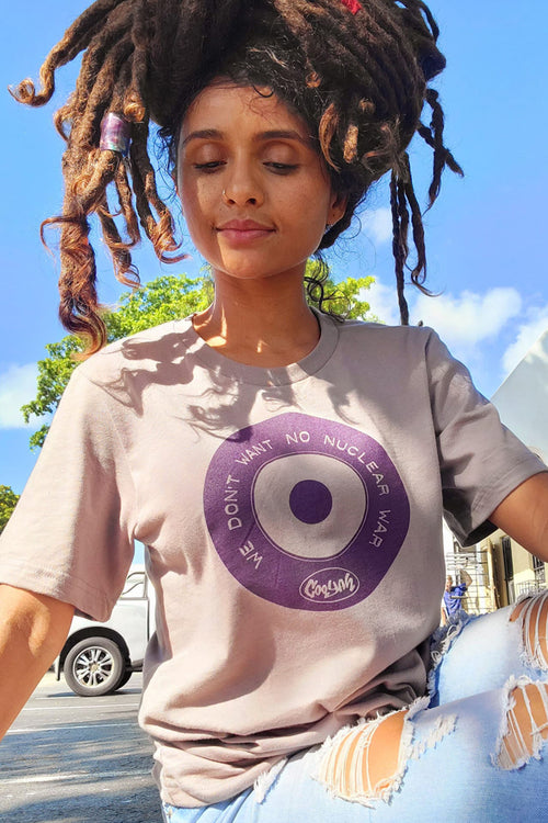 Cooyah Clothing. Women's No More Nuclear War Reggae T-Shirt. Sand, crew neck, short sleeve, graphic tee. Jamaican streetwear inspired by Peter Tosh.