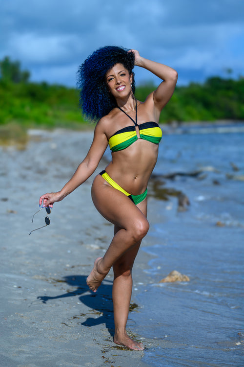 Woman in a Jamaican flag bikini on a beach.  Cooyah clothing brand