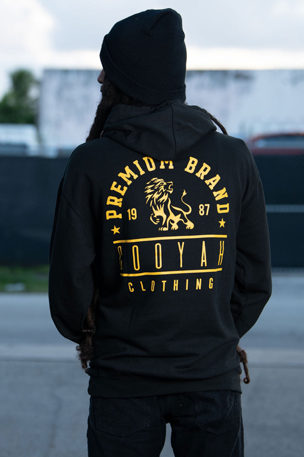 Cooyah Jamaica.  Men's black Premium Brand Hoodie with gold lion screen print on the front and back.  Jamaican streetwear clothing brand.