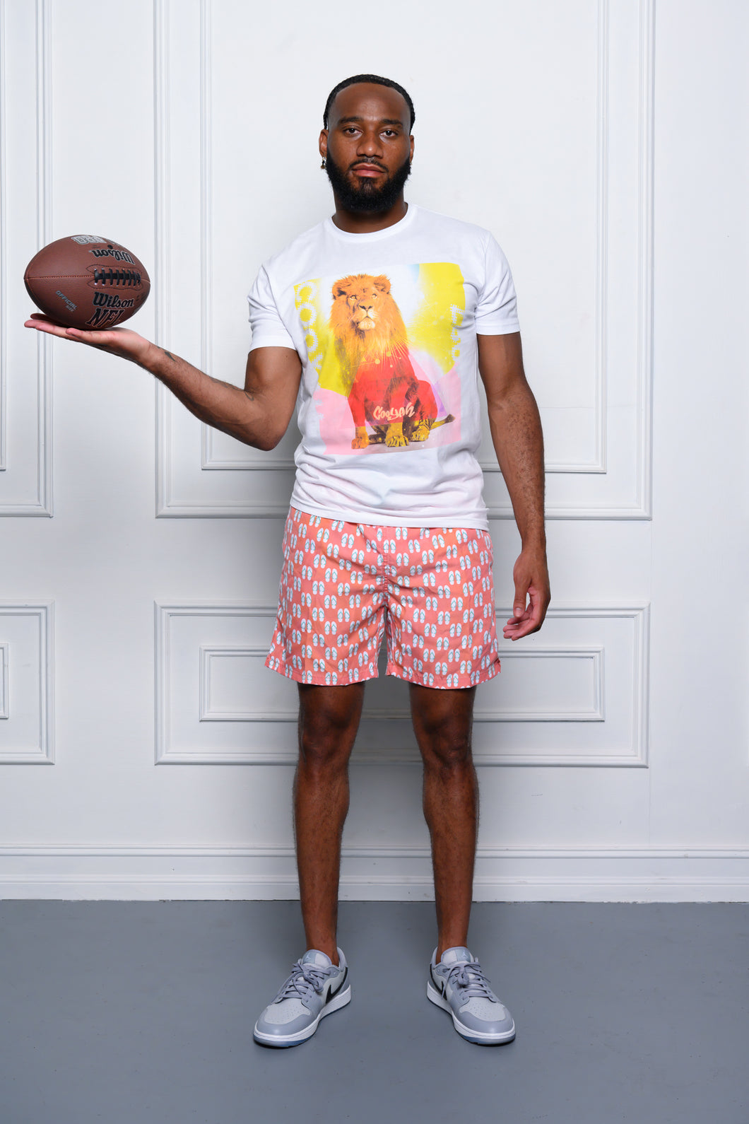 Cooyah Jamaica. Standing Lion Men's Graphic Tee featured on NFL player Tre'Quan Smith.  We are a Jamaican streetwear clothing brand established in 1987.