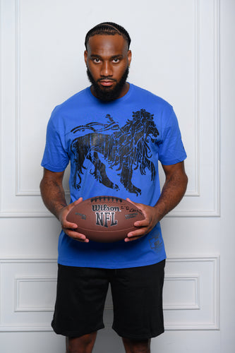 Cooyah Jamaica. Rasta Lion men's short sleeve graphic tee in royal blue.  Model: Tre'quan Smith from the Detroit Lions.  We are a Jamaican owned streetwear clothing brand established in 1987.