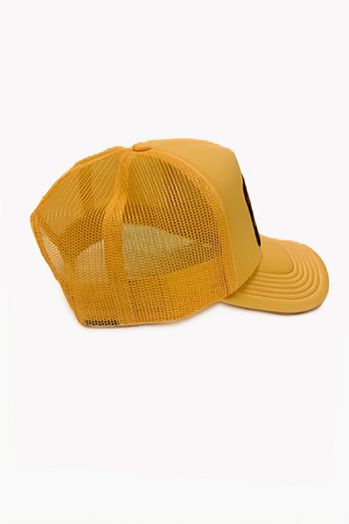 Side view of a  yellow trucker-style cap with a solid yellow structured front panel and a matching yellow mesh back, shown from a three-quarters angle on a plain white background.