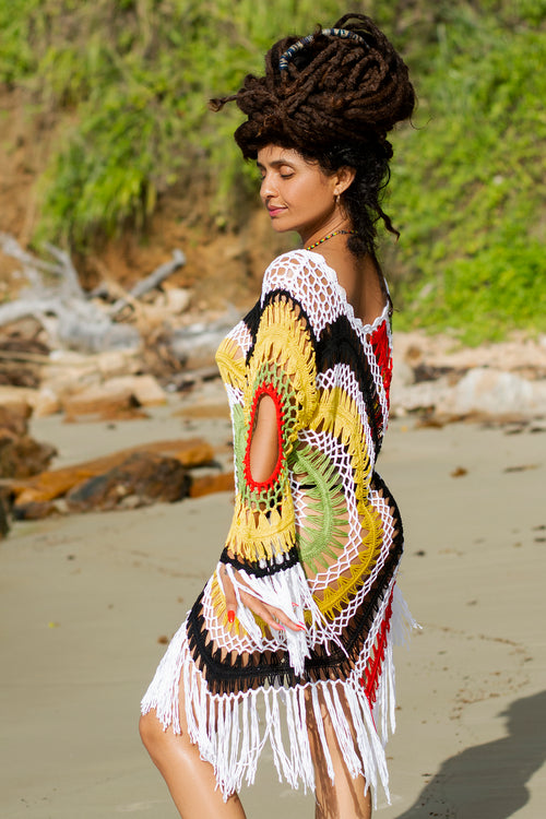 Cooyah Empress -Woman wearing a colorful crochet dress on a beach