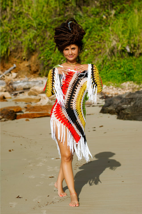 Women's rasta colorful dress with fringe.  Cooyah empress model ii-kaya standing on a beach in Trinidad.