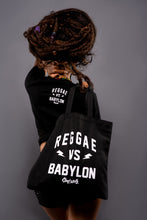 Load image into Gallery viewer, Cooyah Jamaica.  Reggae VS Babylon black cotton tote bag with white screen print.  Jamaican clothing and accessories brand.
