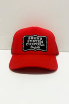 Red cap with 'Sound System Culture' patch on a white background